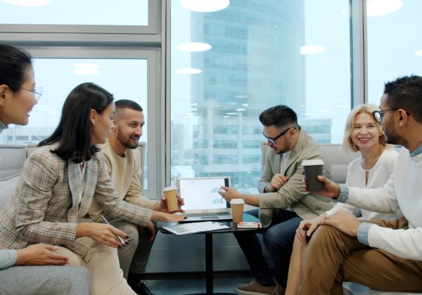 Diverse group of people in a modern office meeting.